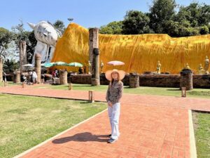 Wandee, licensed private tour guide in Bangkok, standing in front of Wat Khun Inthapramun, an ancient Thai temple in Ayutthaya, Thailand